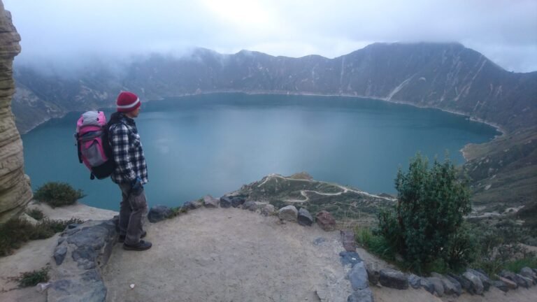 A hiker at a viewpoint on the Quilotoa crater rim